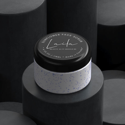 Sunflower face scrub with natural exfoliation in a stylish container on dark pedestals.
